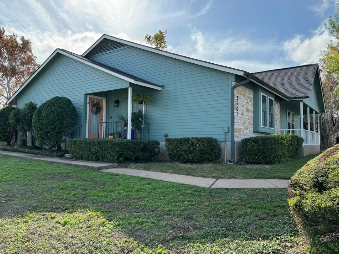 Teal single-story home exterior with stone accents